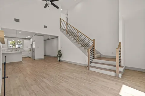 a view of a room with wooden floor and stairs