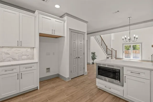 a view of a kitchen with dishwasher and wooden floor
