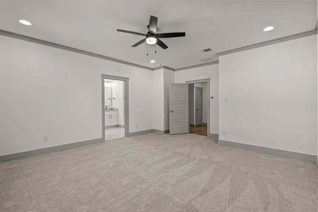 an empty room with closet and ceiling fan