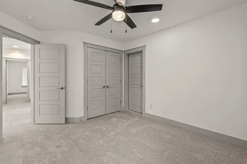 an empty room with chandelier fan
