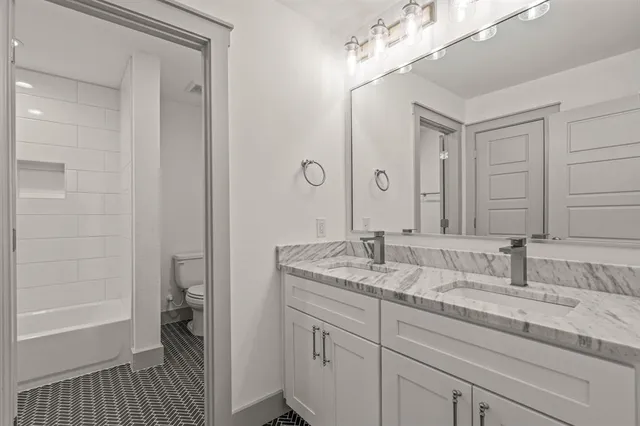 a en suite bathroom with a sink a mirror and a shower