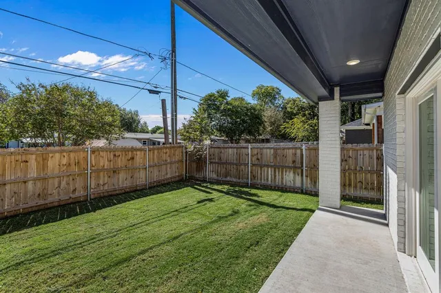 a view of a backyard with wooden fence