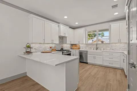 a kitchen with a sink window and cabinets