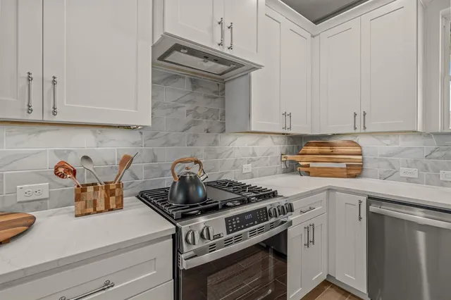 a kitchen with a stove and cabinets