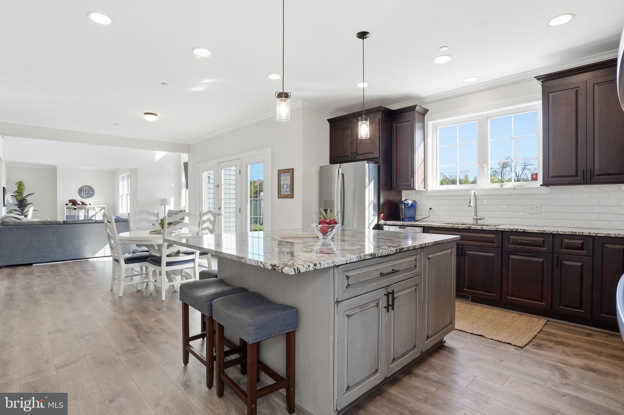 3177 Patuxent River Road Davidsonville, MD 21035 - Photo 11 of 51 a kitchen with stainless steel appliances kitchen island granite countertop a sink and cabinets