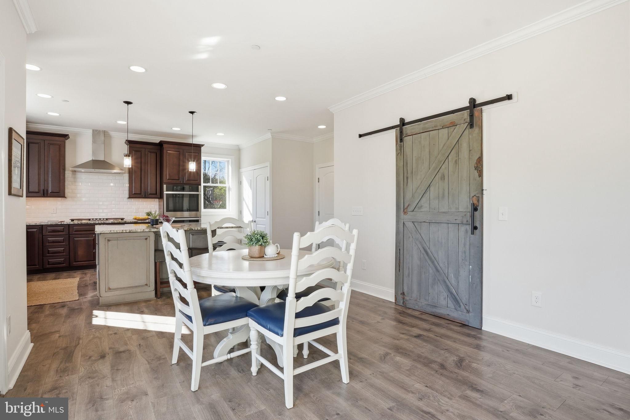 3177 Patuxent River Road Davidsonville, MD 21035 - Photo 12 of 50 a view of a dining room with furniture and wooden floor