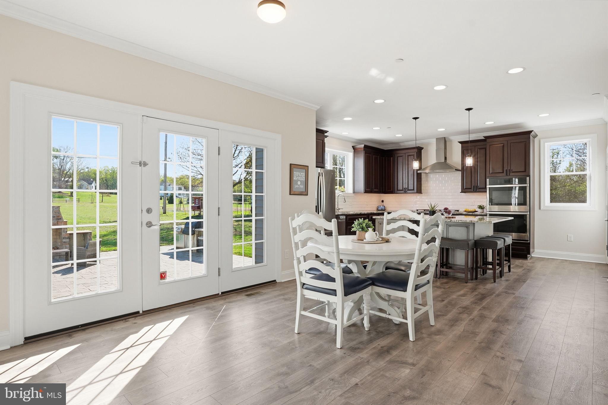 3177 Patuxent River Road Davidsonville, MD 21035 - Photo 14 of 51 a dining room with furniture and wooden floor