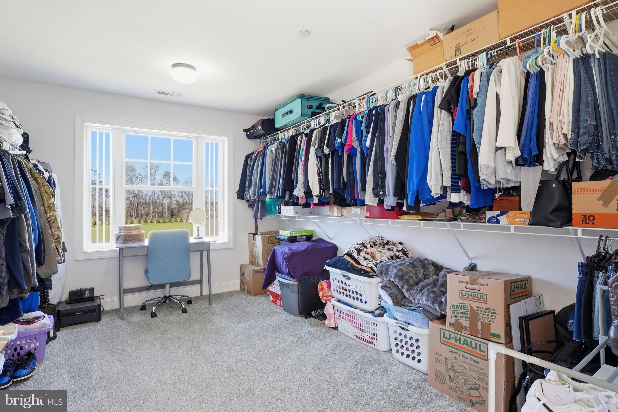 3177 Patuxent River Road Davidsonville, MD 21035 - Photo 23 of 50 a view of walk in closet with clothes and shoes