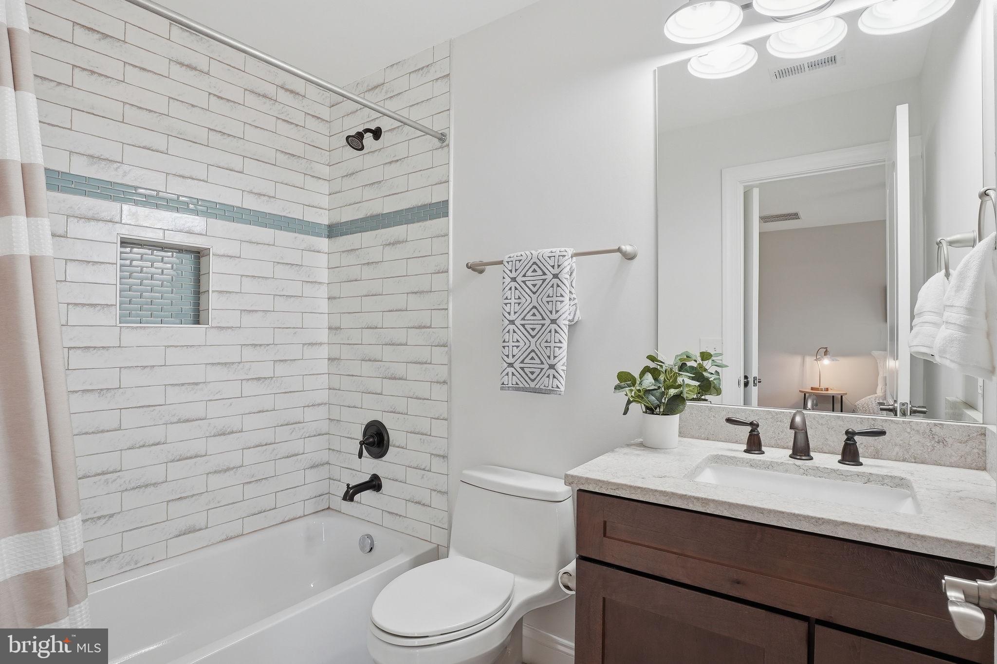 3177 Patuxent River Road Davidsonville, MD 21035 - Photo 25 of 50 a bathroom with a sink a toilet a tub and shower