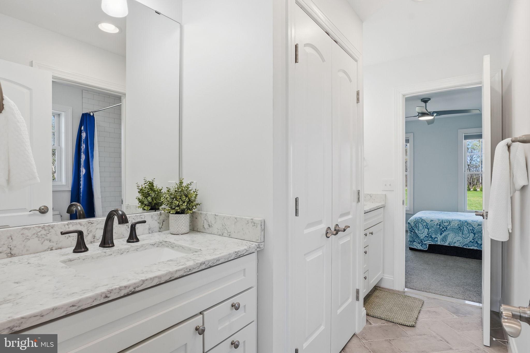 3177 Patuxent River Road Davidsonville, MD 21035 - Photo 30 of 51 a en suite bathroom with a granite countertop sink and a mirror