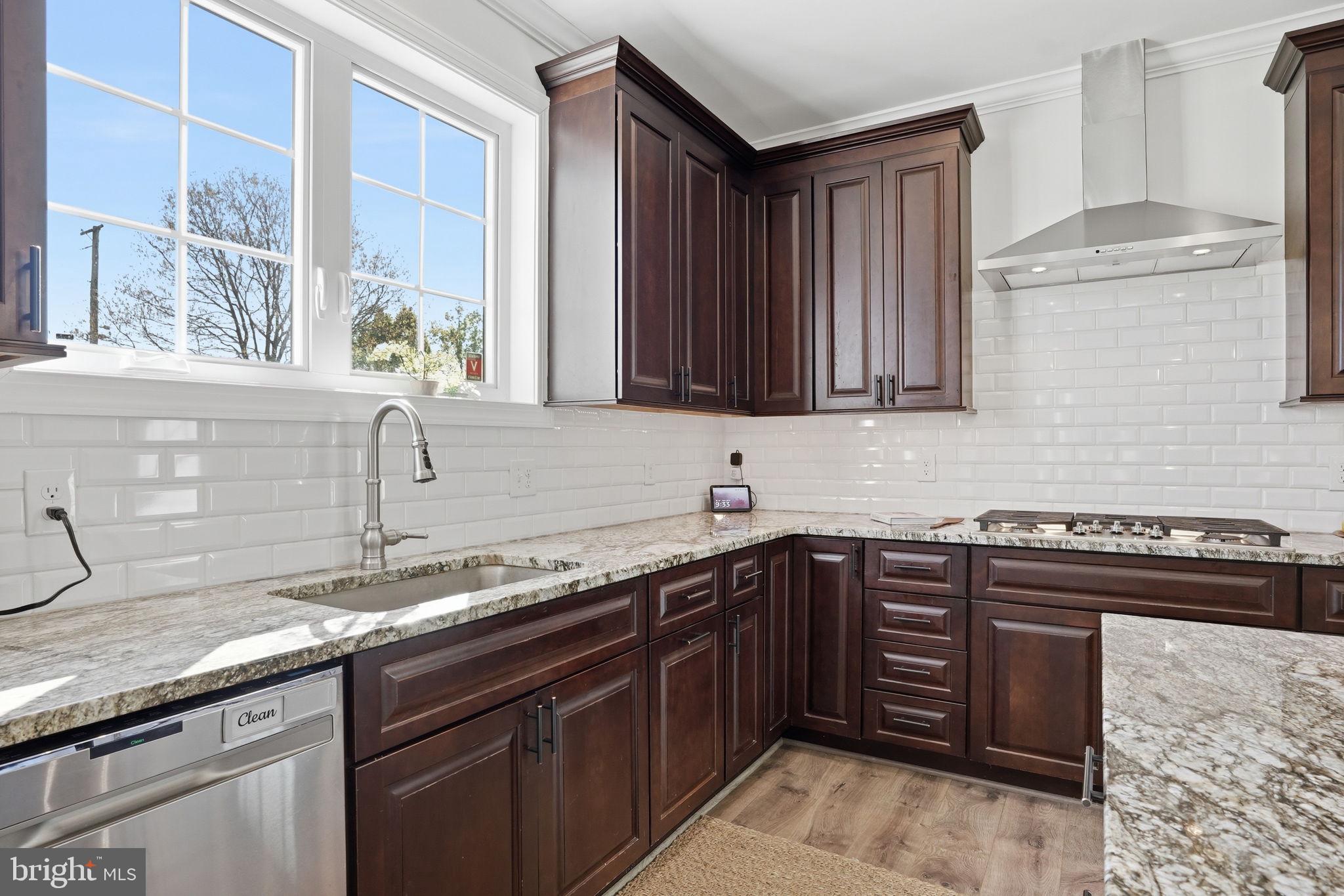 3177 Patuxent River Road Davidsonville, MD 21035 - Photo 10 of 50 a kitchen with stainless steel appliances granite countertop a sink stove and cabinets