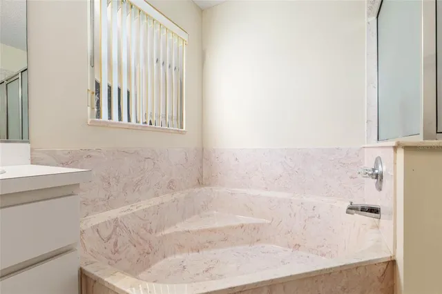 a bathroom with a shower and a tub