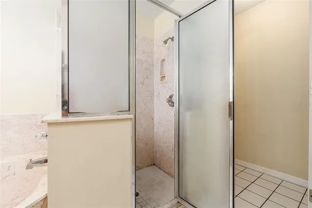a living room with furniture a rug and a floor to ceiling window