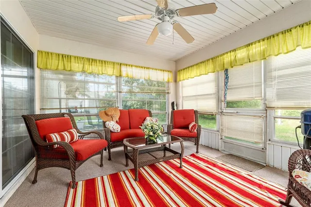 a view of a house with a yard and large tree