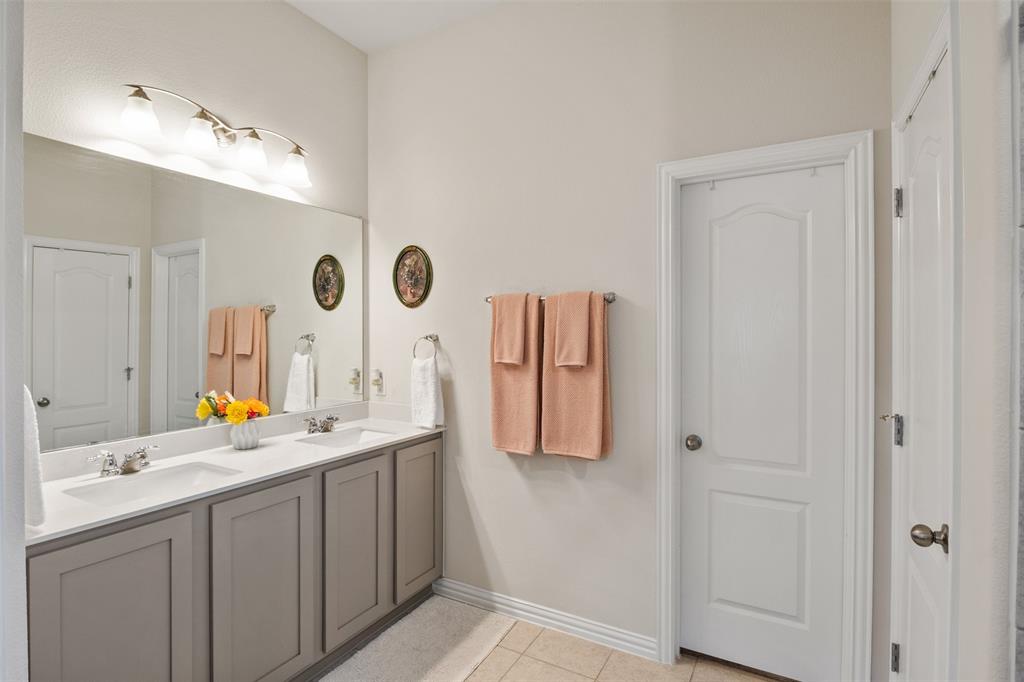 317 Timberline Drive Midlothian, TX 76065 - Photo 13 of 30 a bathroom with a double vanity sink and a mirror