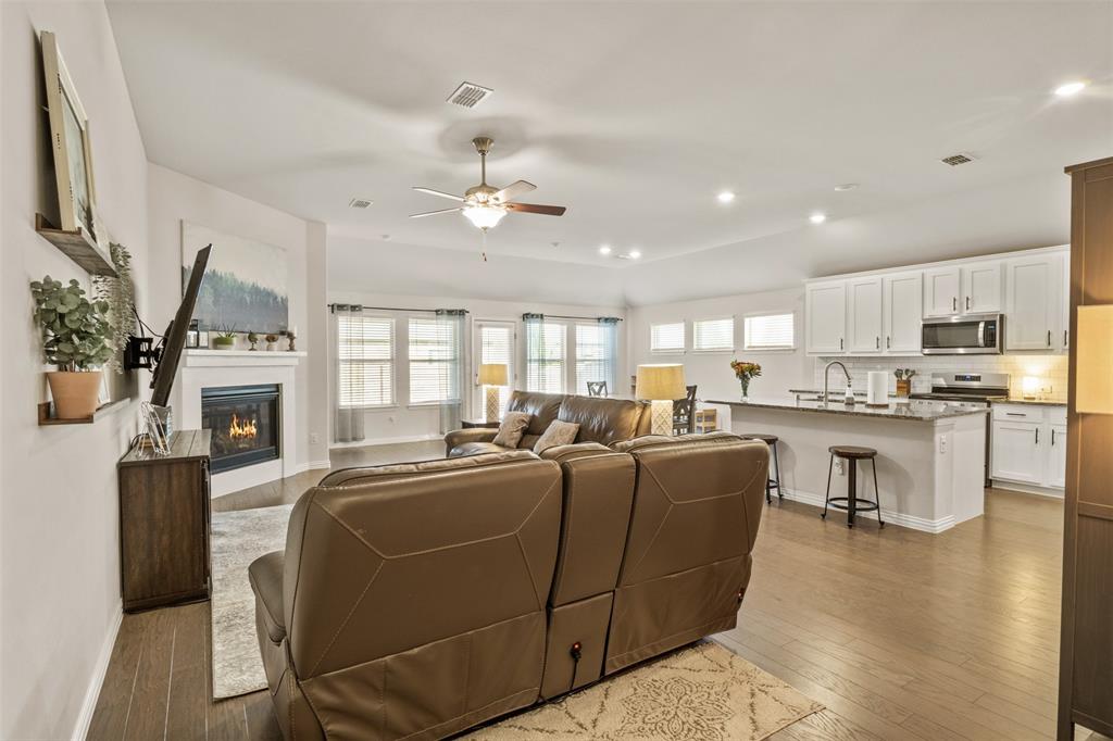 317 Timberline Drive Midlothian, TX 76065 - Photo 5 of 30 a living room with fireplace furniture and a kitchen view