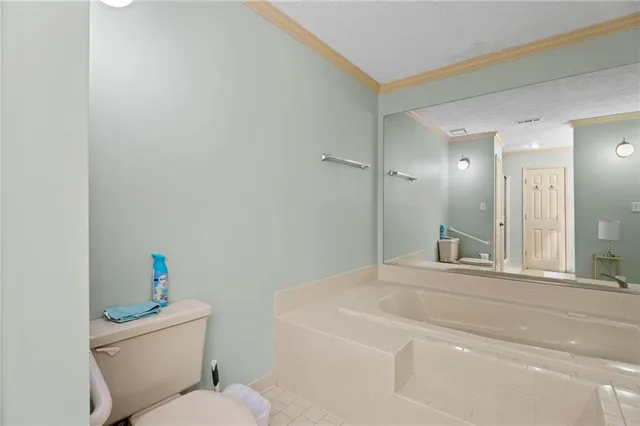 a bathroom with a toilet sink and a mirror