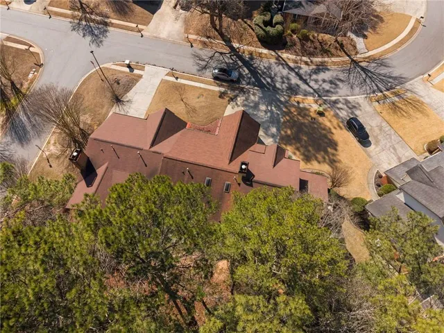 an aerial view of a house with a yard basket ball court and outdoor seating