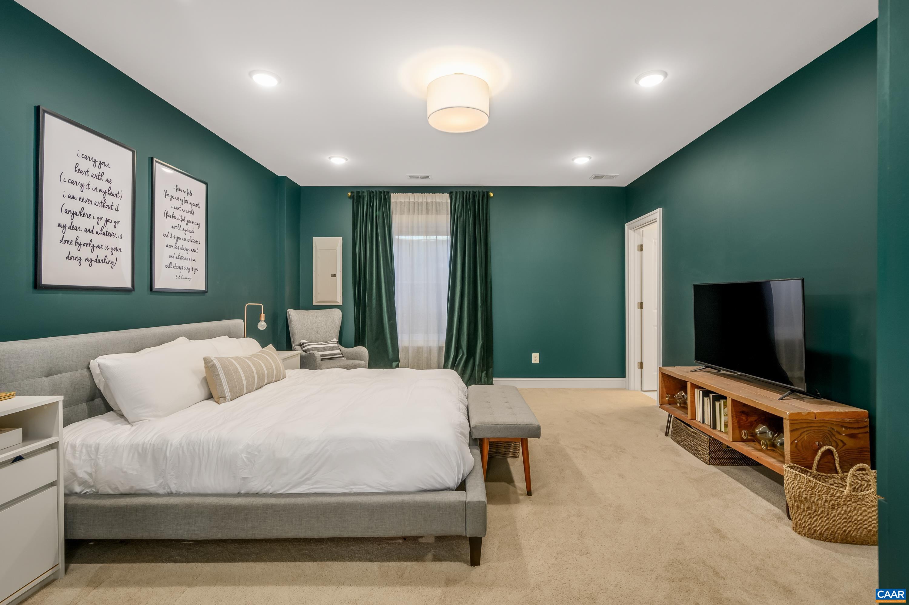 147 Junction Lane Charlottesville, VA 22902 - Photo 21 of 30 a bedroom with a bed and a flat screen television