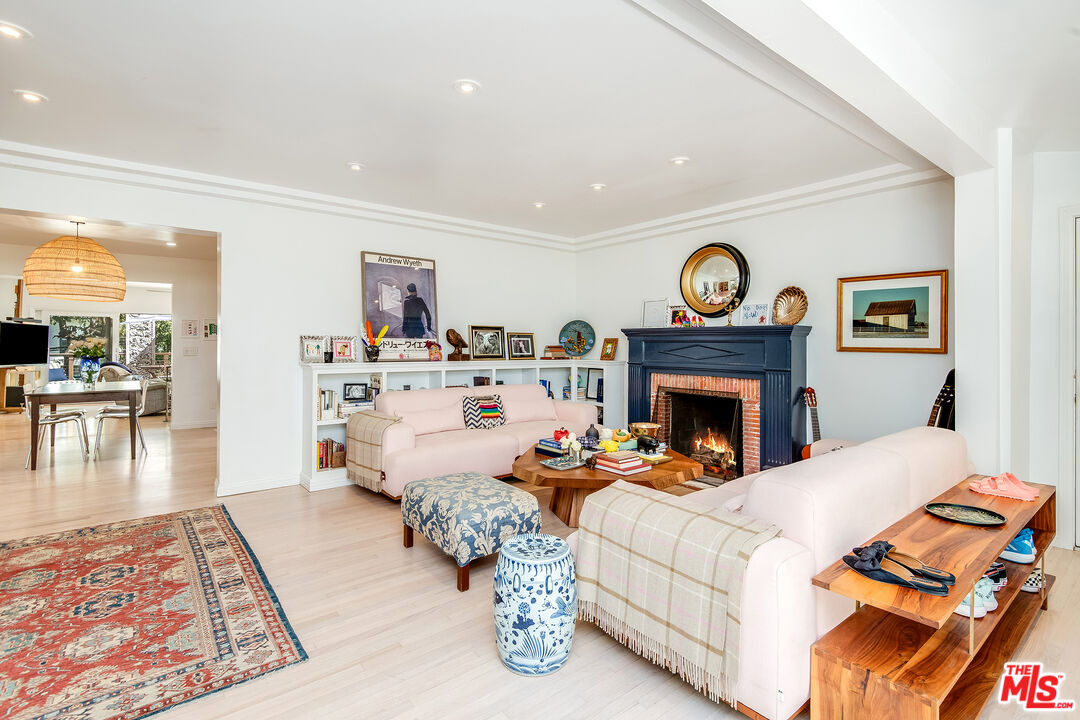 3152 Ellington Drive Los Angeles, CA 90068 - Photo 1 of 21 a living room with furniture a clock and a fireplace