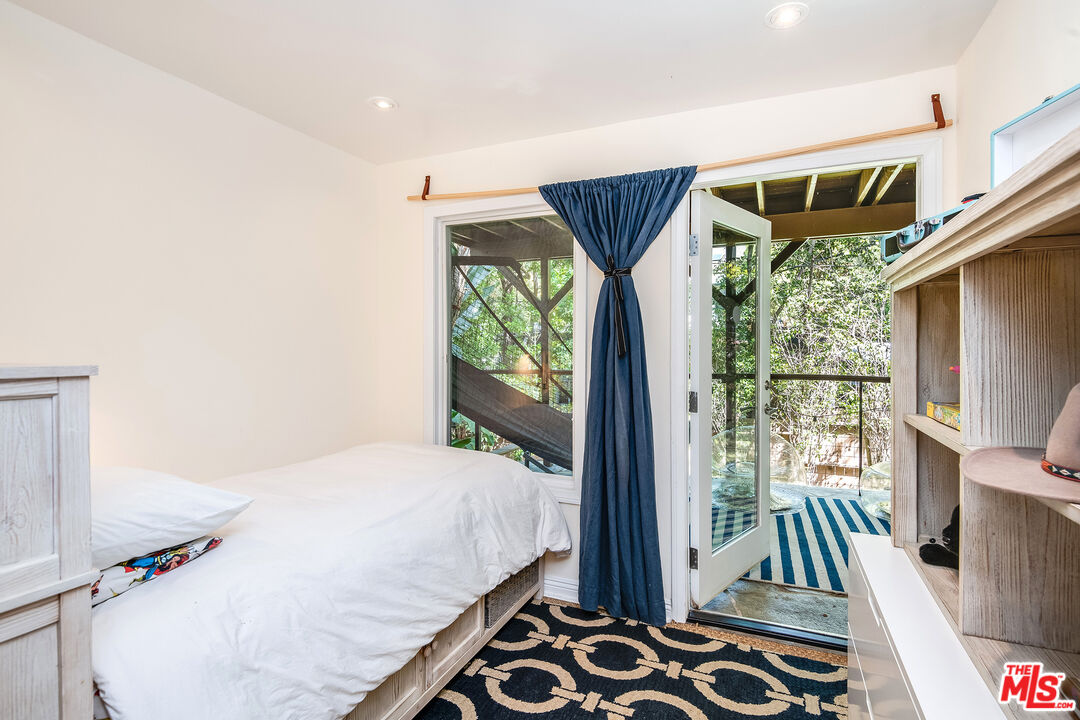 3152 Ellington Drive Los Angeles, CA 90068 - Photo 17 of 21 a bedroom with a bed and a window