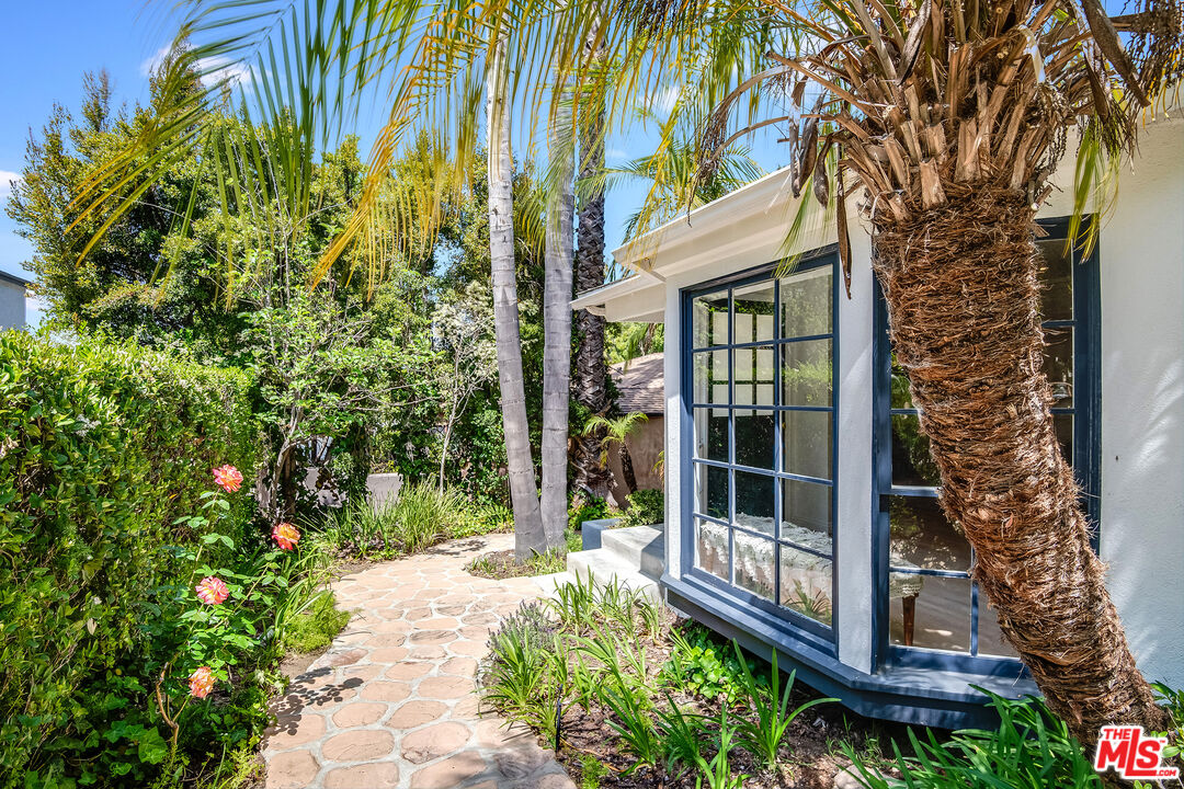 3152 Ellington Drive Los Angeles, CA 90068 - Photo 2 of 21 a view of a brick house with a large windows and flower plants