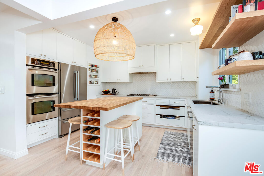 3152 Ellington Drive Los Angeles, CA 90068 - Photo 3 of 21 a kitchen with stainless steel appliances a stove a sink and cabinets