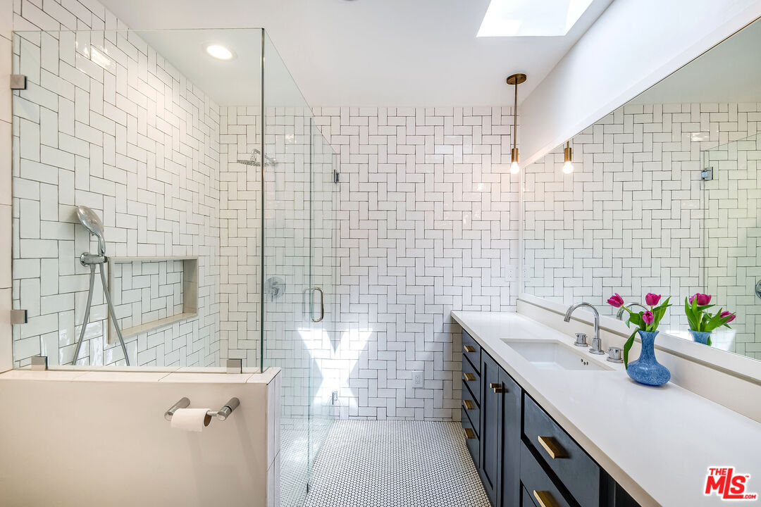 3152 Ellington Drive Los Angeles, CA 90068 - Photo 6 of 21 a bathroom with a sink a vanity and a shower