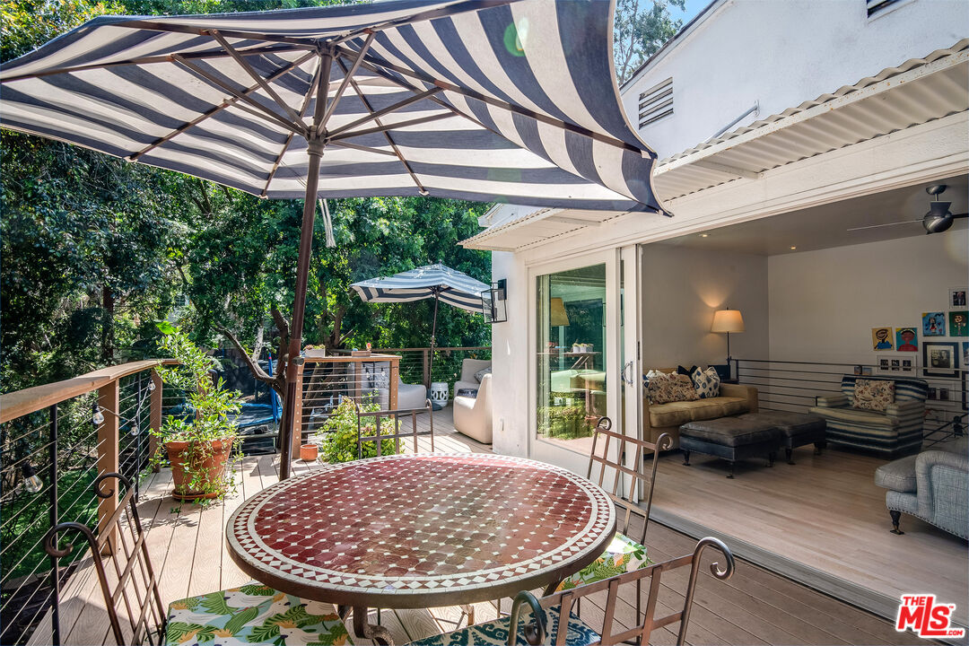 3152 Ellington Drive Los Angeles, CA 90068 - Photo 9 of 21 a view of a patio with a table chairs and a backyard