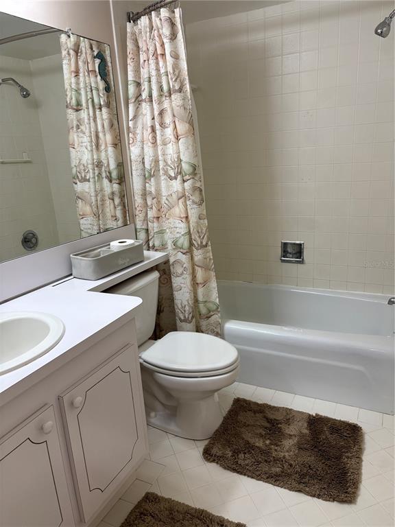 4750 Cove Circle, Unit 904 St. Petersburg, FL 33708 - Photo 23 of 37 a bathroom with a sink toilet and shower