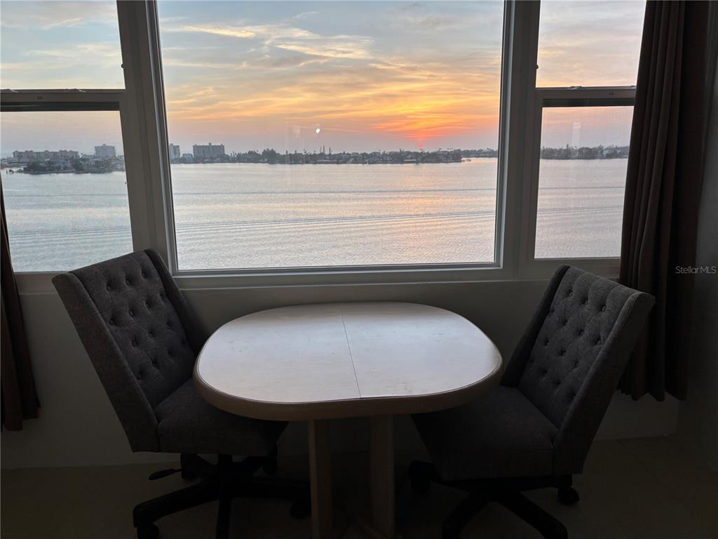 4750 Cove Circle, Unit 904 St. Petersburg, FL 33708 - Photo 24 of 37 a view of a dining room with furniture window and outside view