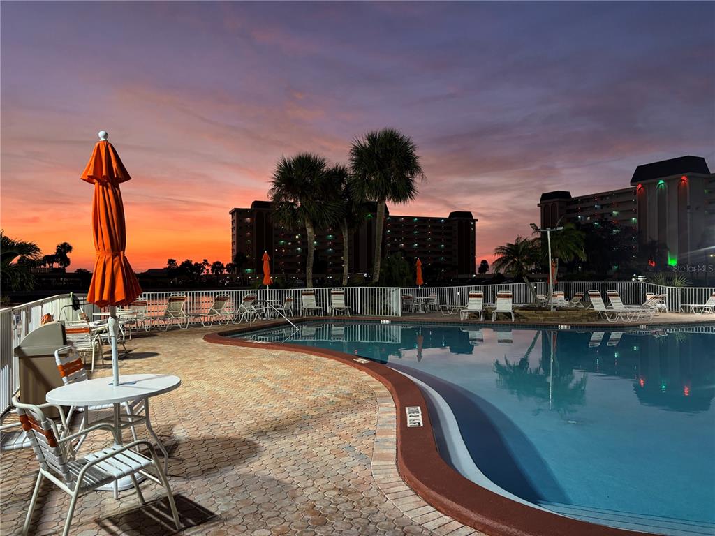 4750 Cove Circle, Unit 904 St. Petersburg, FL 33708 - Photo 32 of 37 a view of a swimming pool with outdoor seating