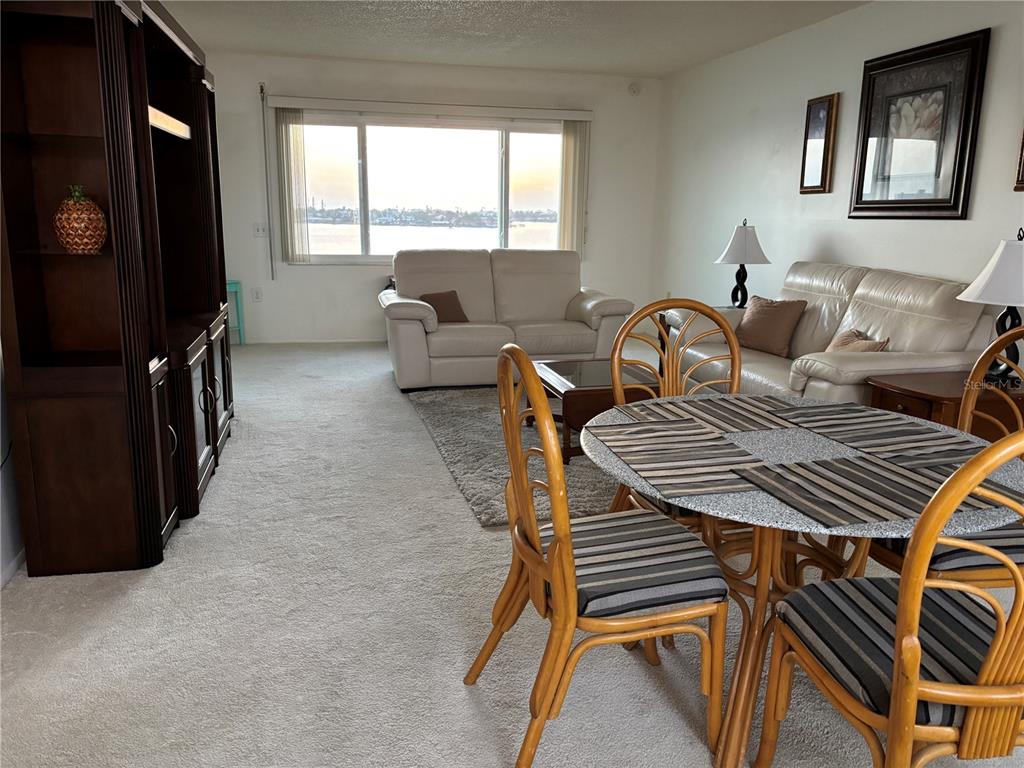 4750 Cove Circle, Unit 904 St. Petersburg, FL 33708 - Photo 6 of 37 a bedroom with furniture and a window