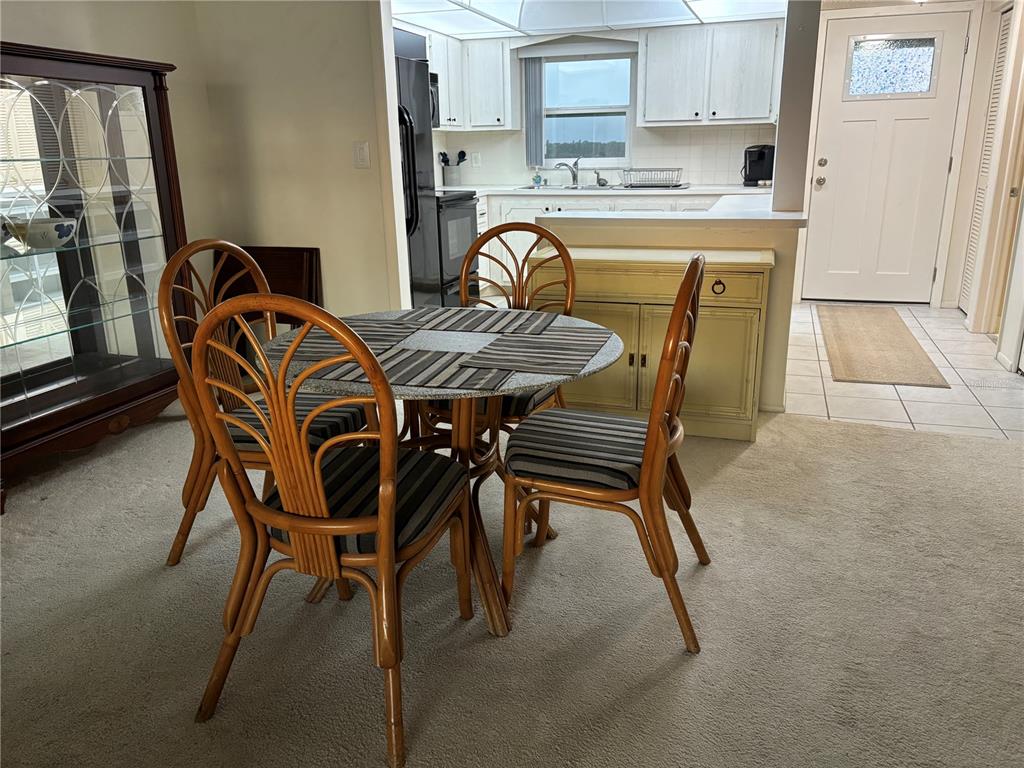 4750 Cove Circle, Unit 904 St. Petersburg, FL 33708 - Photo 7 of 37 a dining room with furniture and window