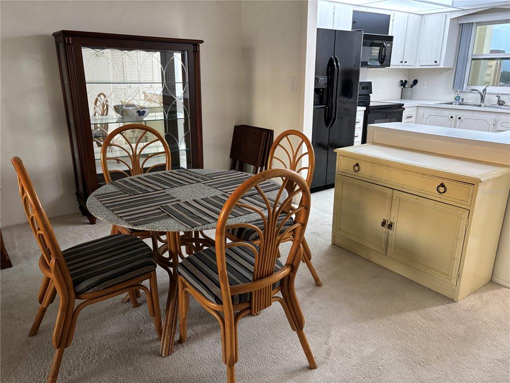 4750 Cove Circle, Unit 904 St. Petersburg, FL 33708 - Photo 8 of 37 a dining room with furniture and window