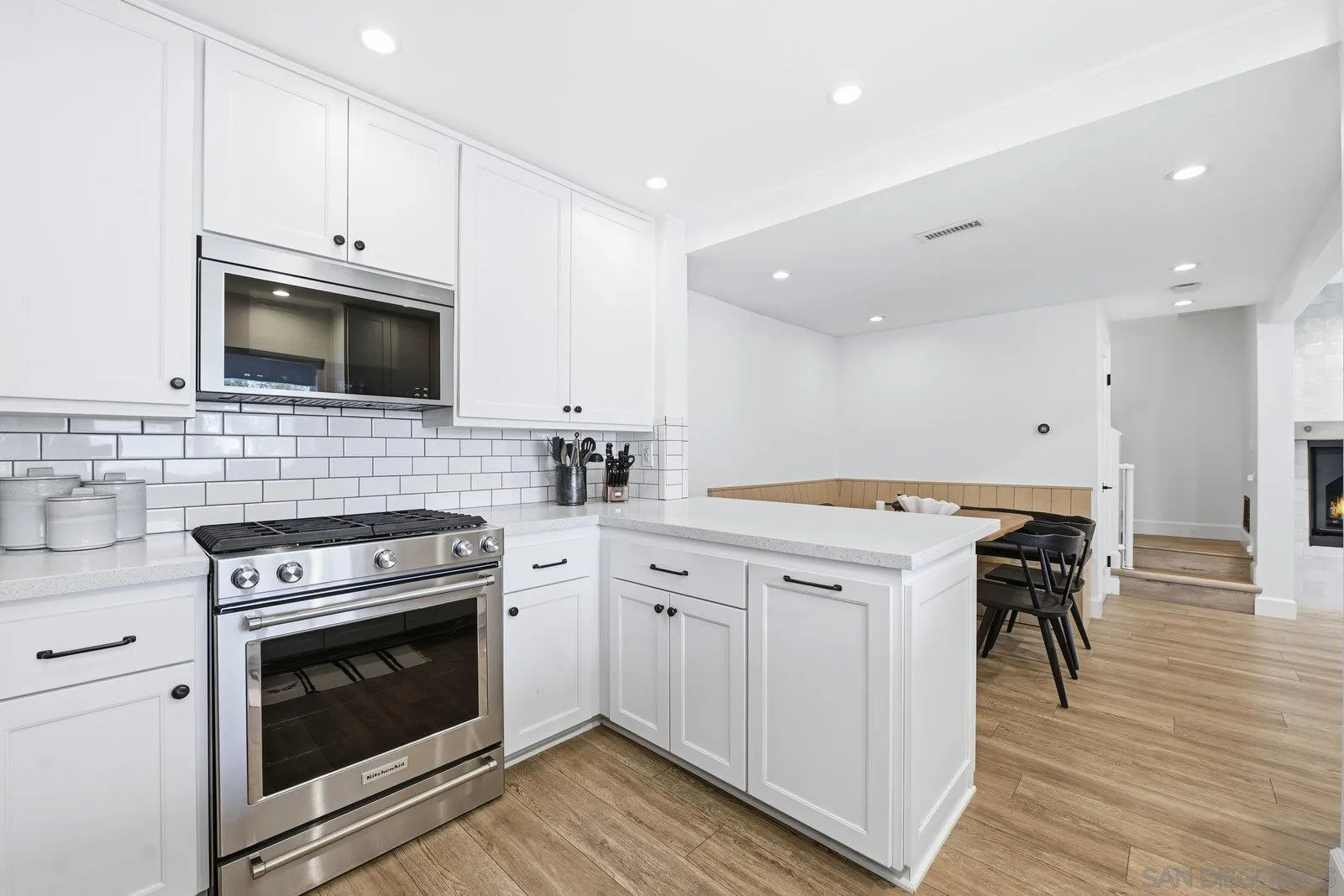 a kitchen with a stove top oven and cabinets