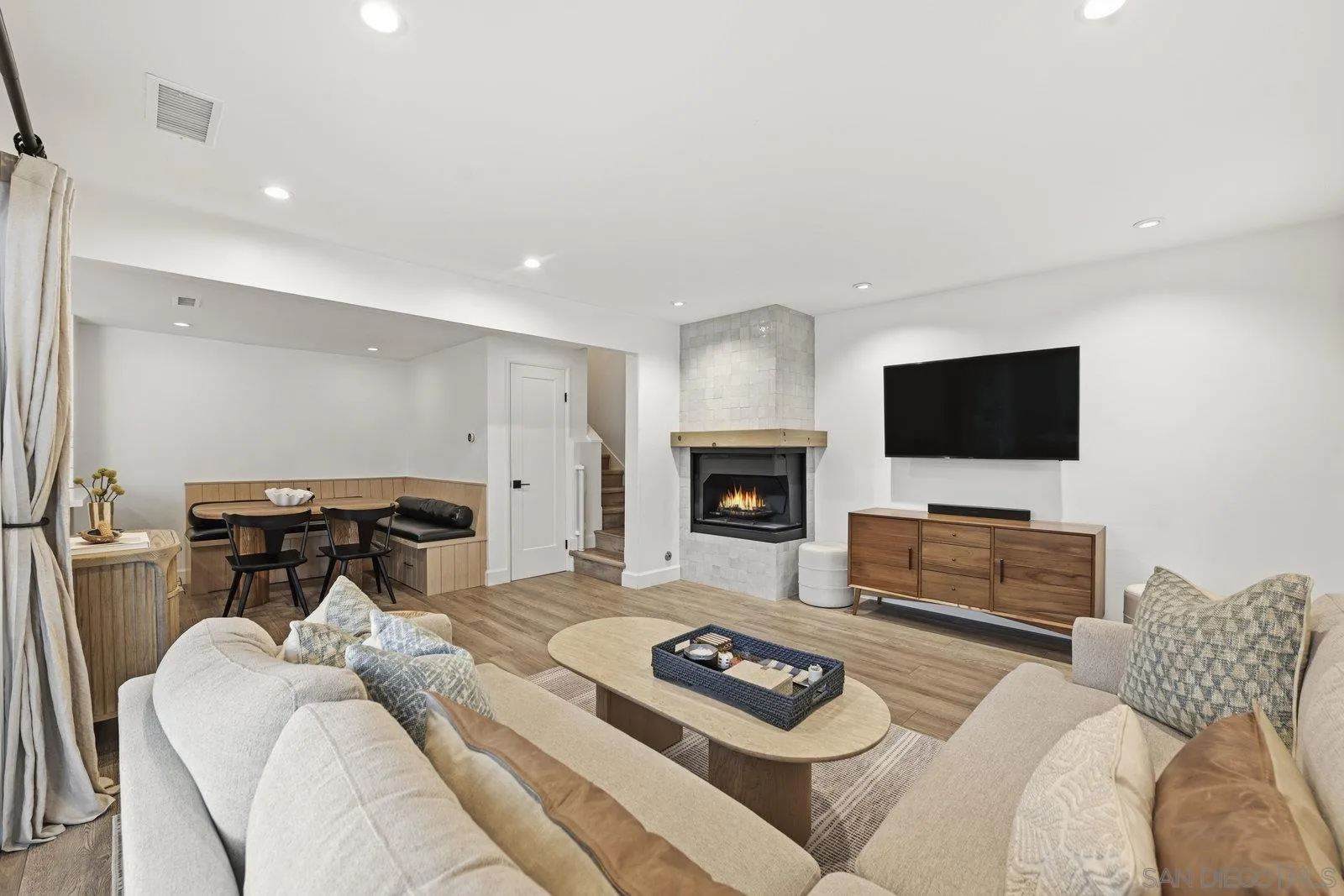 1422 Caminito Septimo Cardiff, CA 92007 - Photo 13 of 27 a living room with furniture a flat screen tv and a fireplace