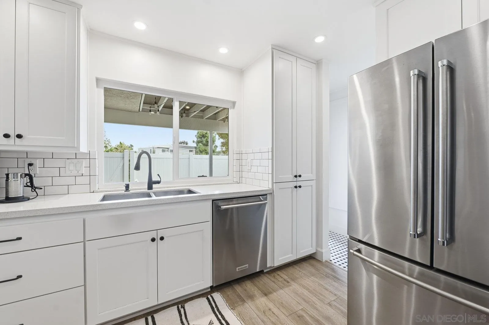 1422 Caminito Septimo Cardiff, CA 92007 - Photo 2 of 27 a kitchen with stainless steel appliances a sink stove and refrigerator