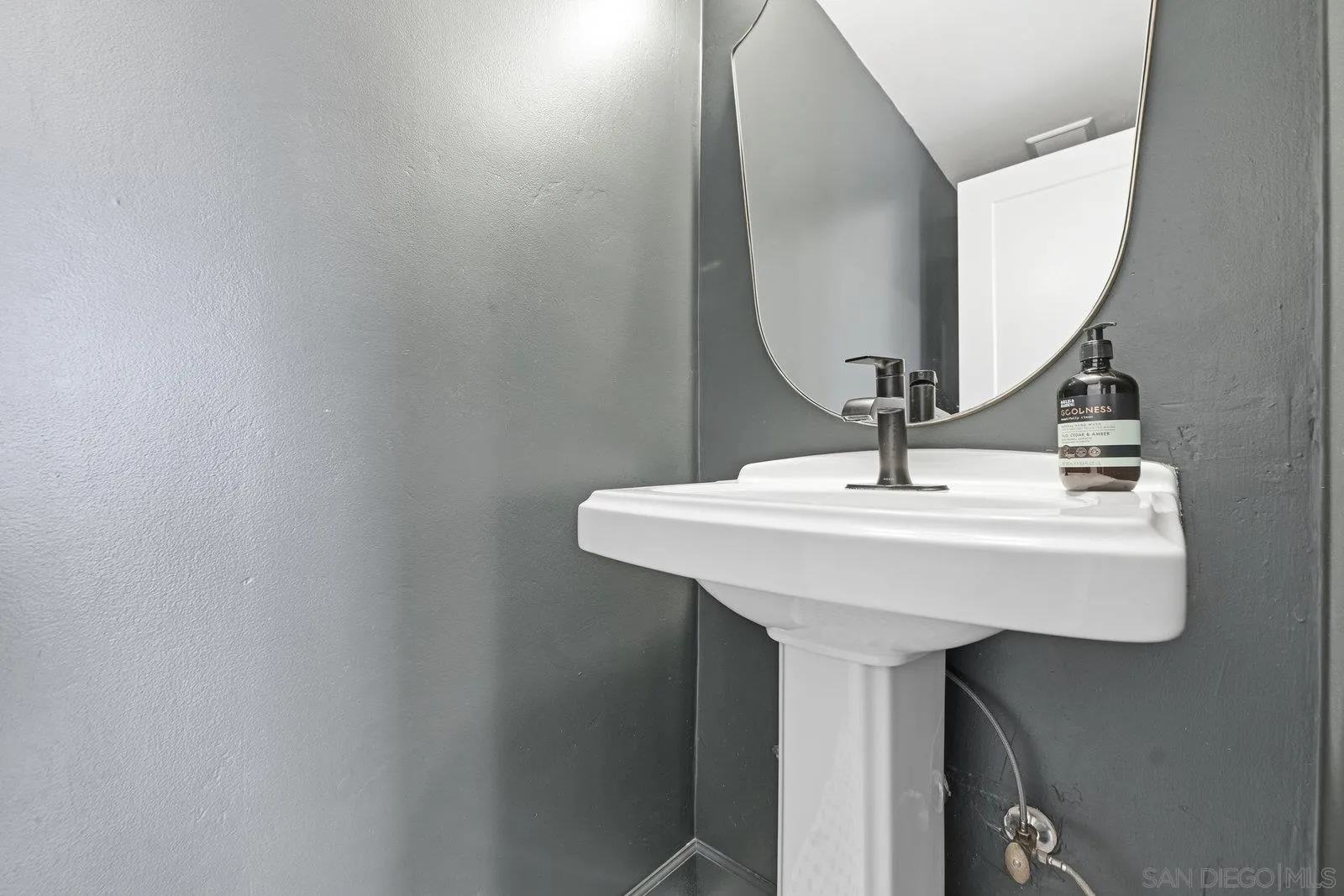 1422 Caminito Septimo Cardiff, CA 92007 - Photo 21 of 27 a bathroom with a sink and a mirror