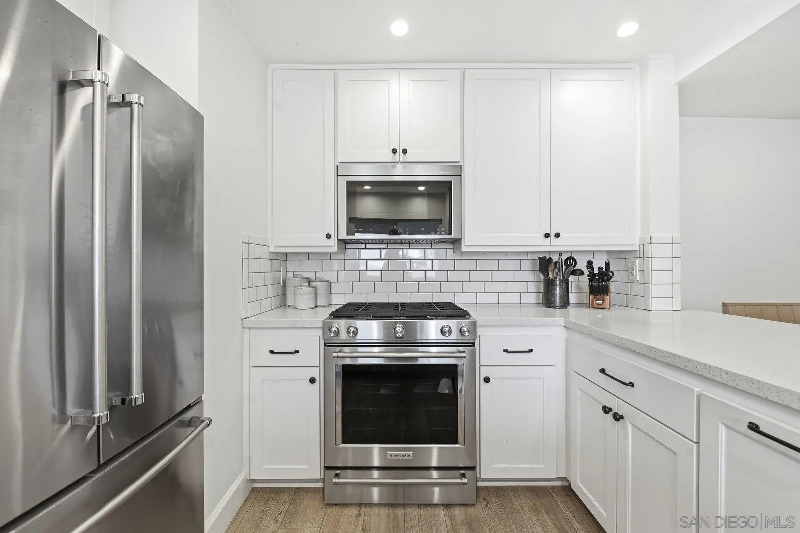1422 Caminito Septimo Cardiff, CA 92007 - Photo 3 of 27 a kitchen with stainless steel appliances a stove a microwave and a sink