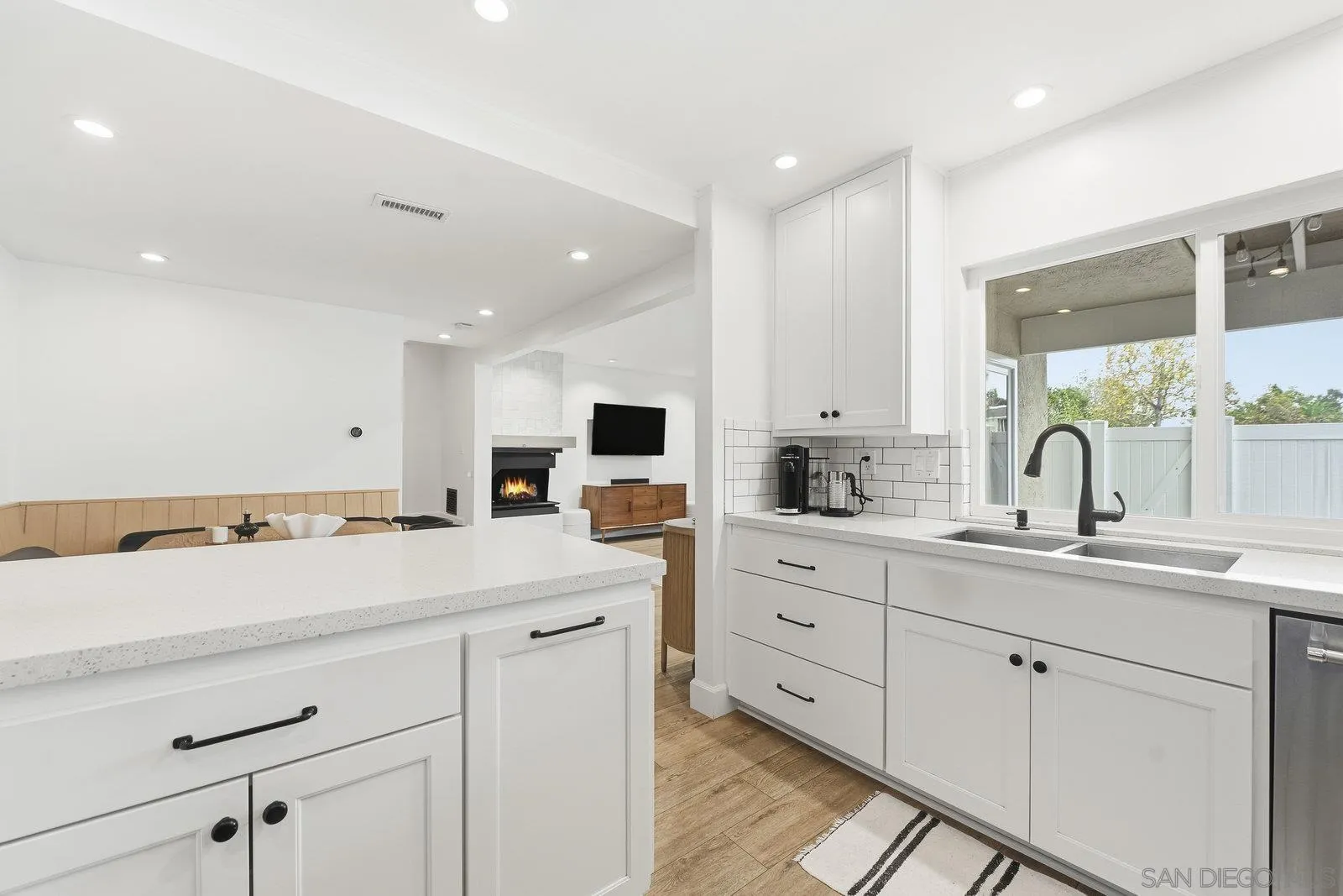 1422 Caminito Septimo Cardiff, CA 92007 - Photo 6 of 27 a kitchen with a sink white cabinets and white appliances