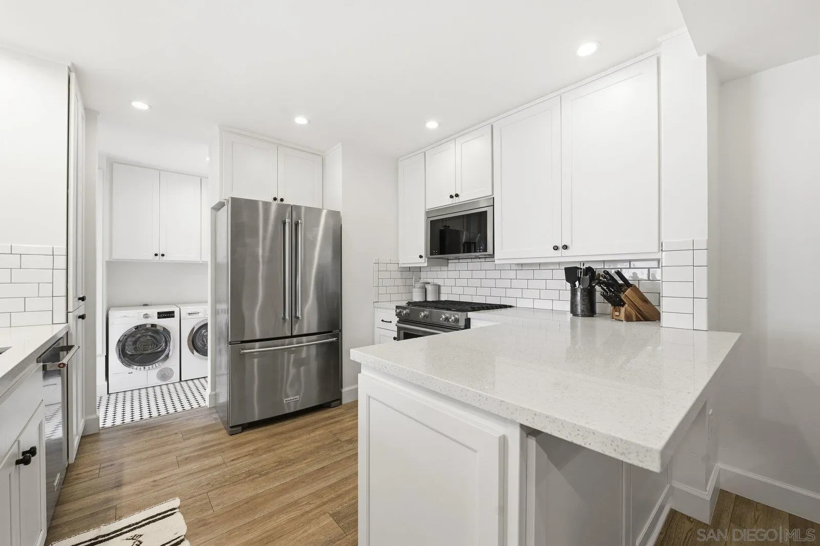 1422 Caminito Septimo Cardiff, CA 92007 - Photo 7 of 27 a kitchen with a refrigerator a stove top oven a sink and a refrigerator
