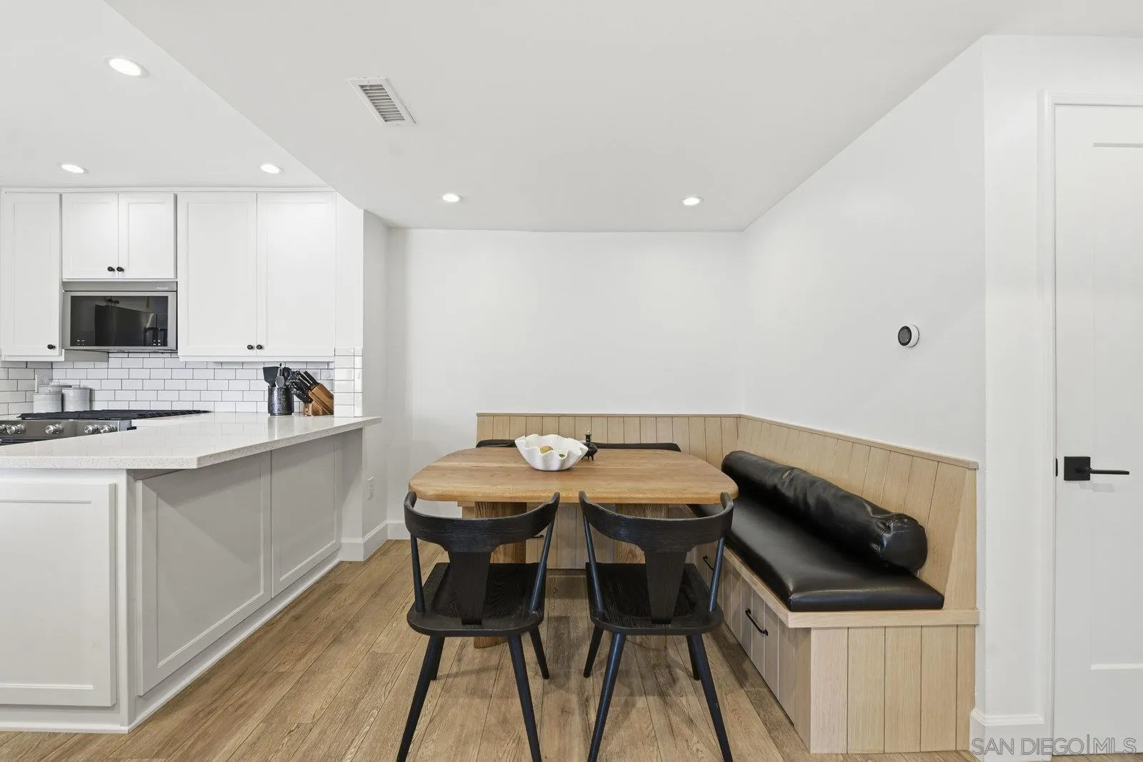 1422 Caminito Septimo Cardiff, CA 92007 - Photo 8 of 27 a kitchen with a sink chairs and cabinets