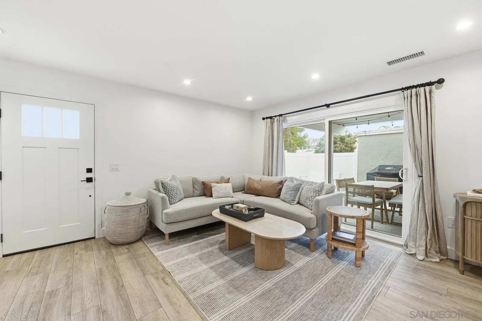 1422 Caminito Septimo Cardiff, CA 92007 - Photo 10 of 27 a living room with furniture a rug and a floor to ceiling window