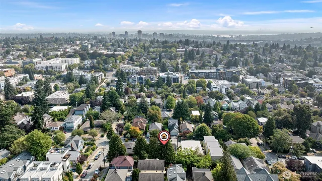 an aerial view of residential houses with city view