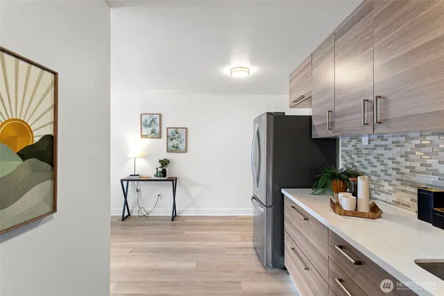 a kitchen with stainless steel appliances kitchen island granite countertop a refrigerator and a sink