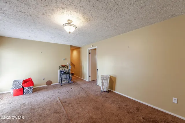 a living room filled with furniture and a wooden floor