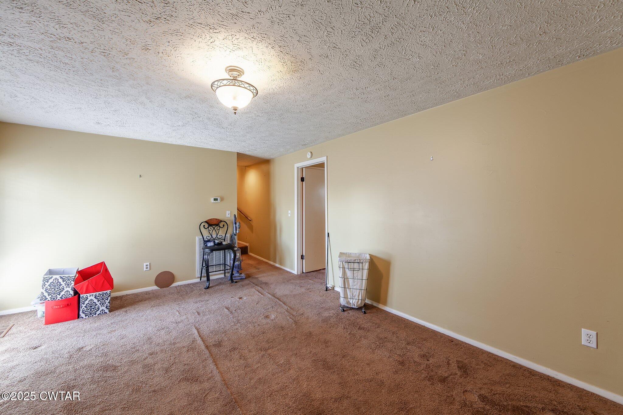 196 Pierce Road Beech Bluff, TN 38313 - Photo 12 of 63 a view of a room with toys and a ceiling fan