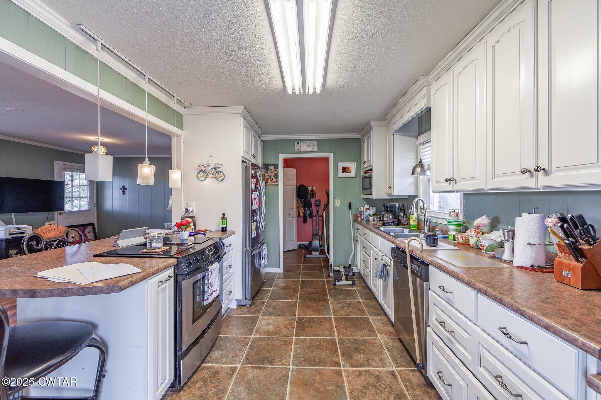 196 Pierce Road Beech Bluff, TN 38313 - Photo 21 of 63 a kitchen with a stove a sink and a refrigerator