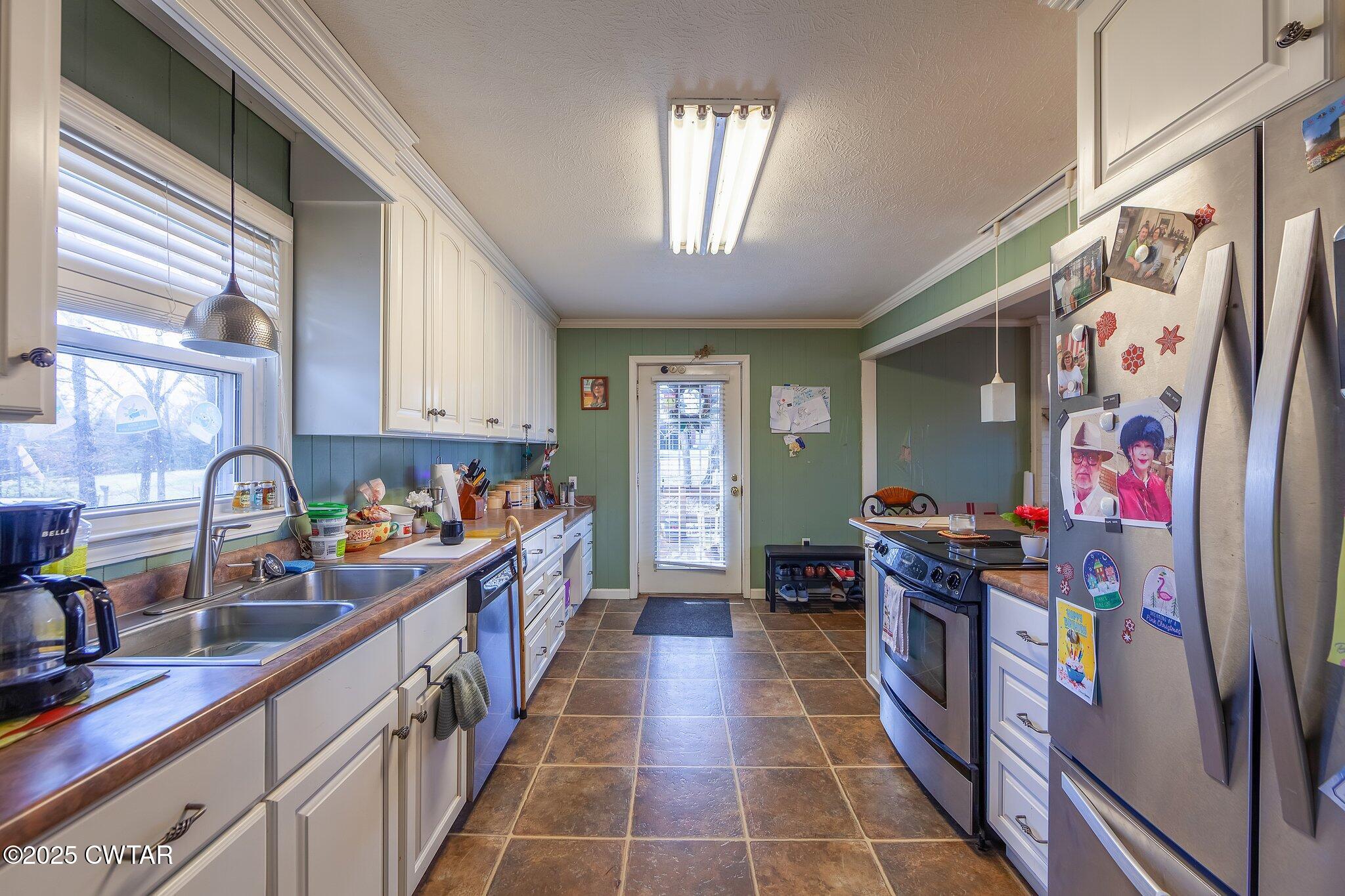 196 Pierce Road Beech Bluff, TN 38313 - Photo 23 of 63 a kitchen with stainless steel appliances a sink and a stove